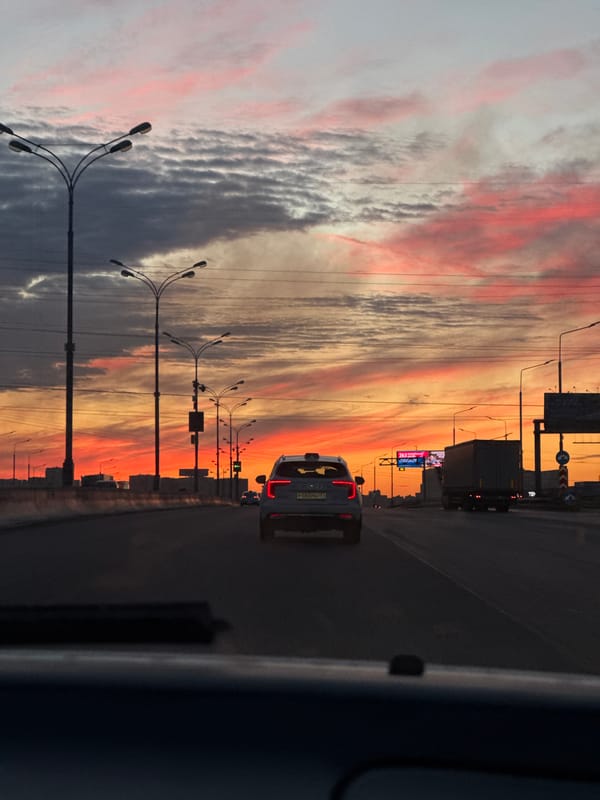 Sunset sky over Dzerzhinsky highway, shot from a moving vehicle