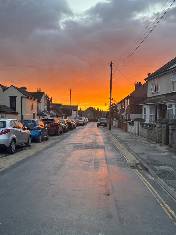 Dramatic orange sunset illuminates Caister-on-Sea streets and beach