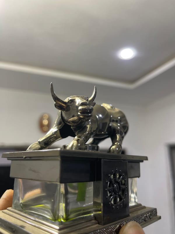 Charging bull figurine on decorative pedestal, Abuja