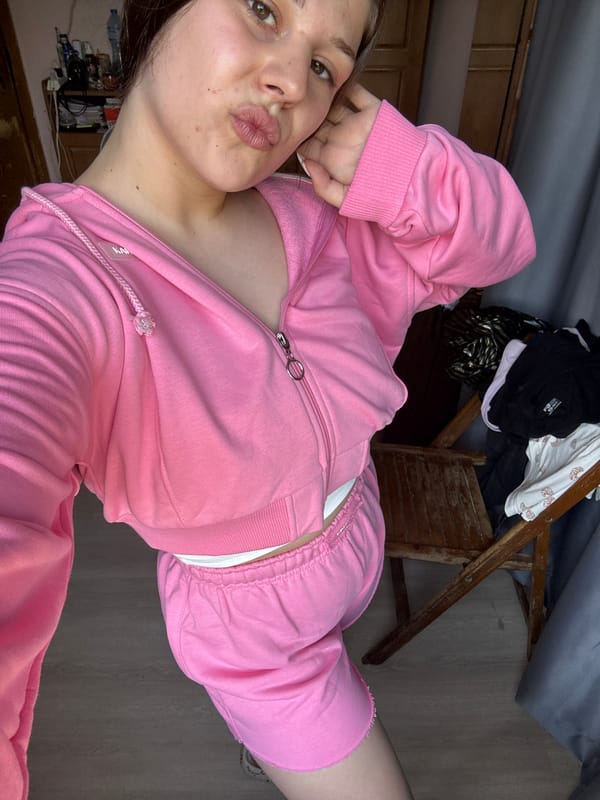 Bedroom selfie session in a pink tracksuit