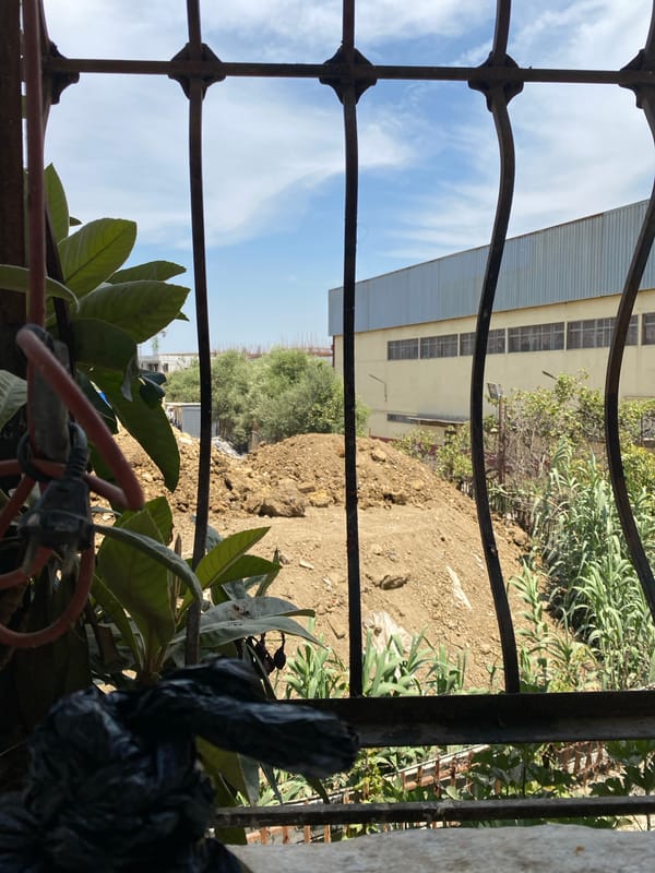 Coffee indoors, construction outside — a quiet moment in Baraki