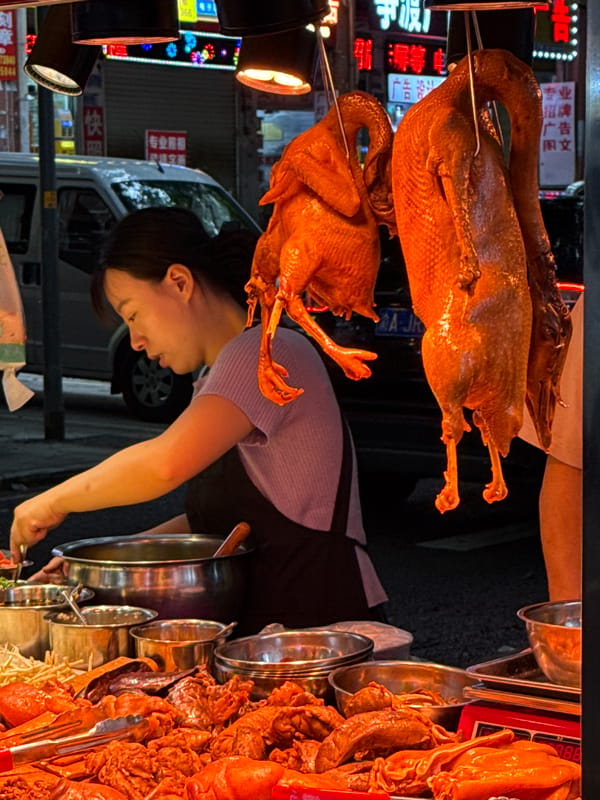 Street vendors operate food stalls in Nan'an District market