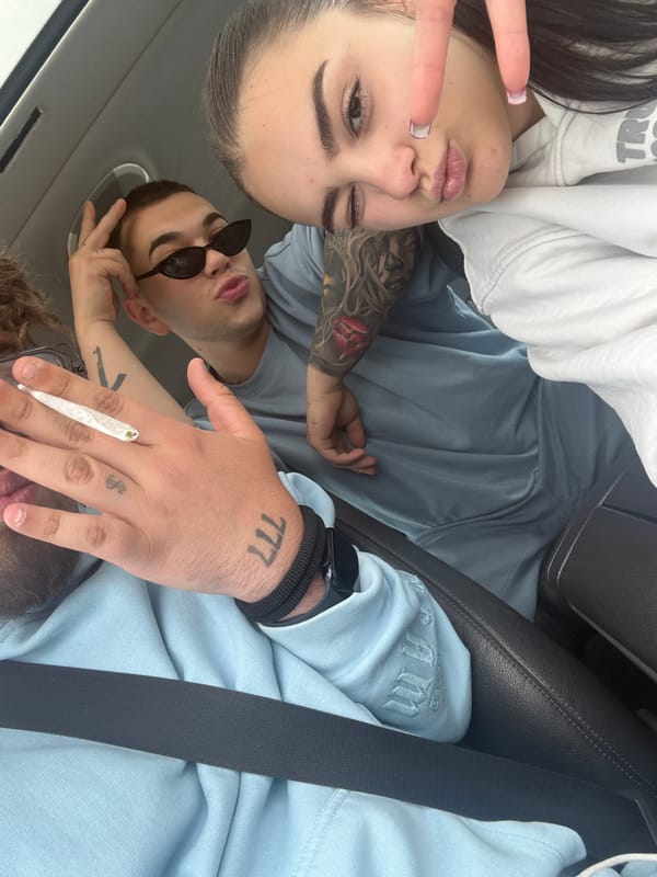 Three friends photographed together inside car in Belo Pole