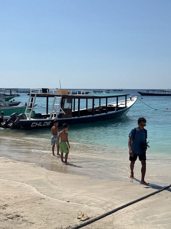 Gili Islands dive boats and beach life on a busy morning