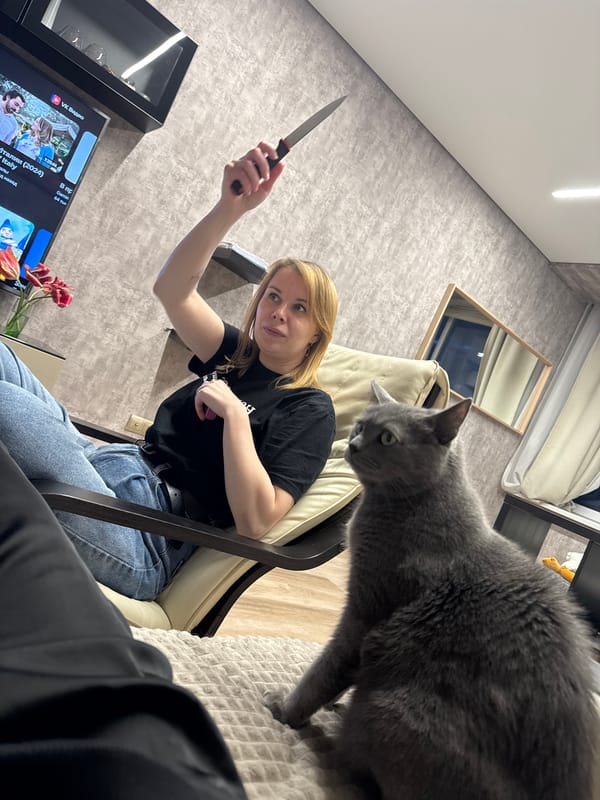 Woman and gray cat captured in domestic indoor scene