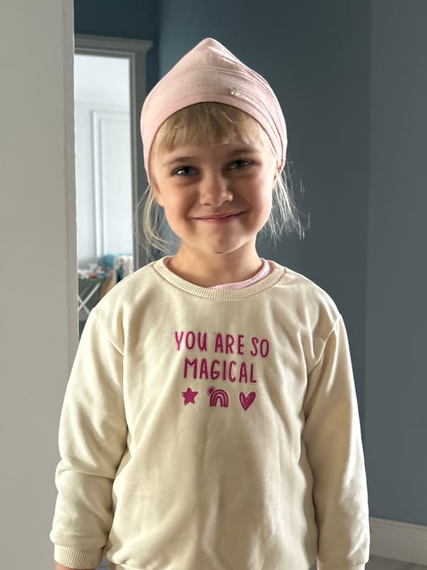 Indoor portrait series featuring a pink headscarf and 'YOU ARE SO MAGICAL' sweatshirt