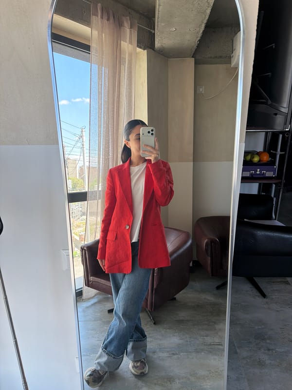 Person takes mirror selfie in white shirt, red blazer in Yerevan