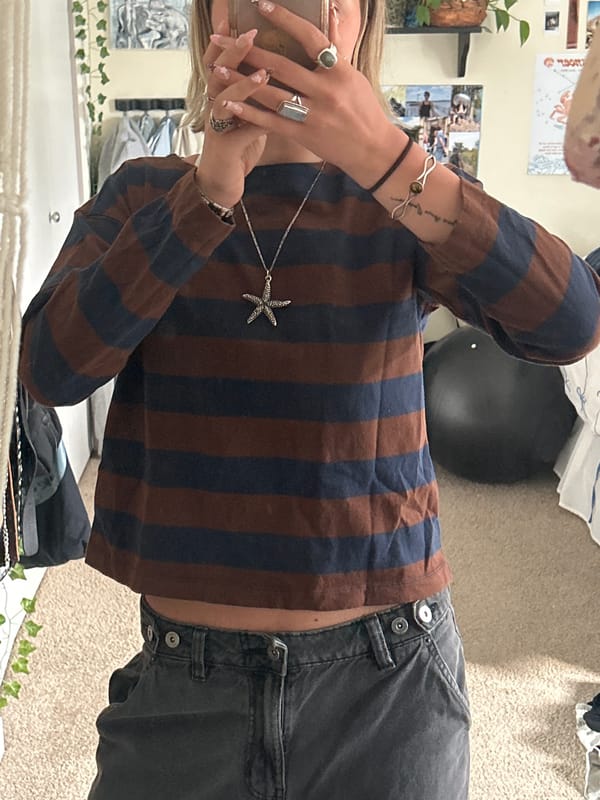 Person photographed indoors wearing distinctive jewelry in Whistler