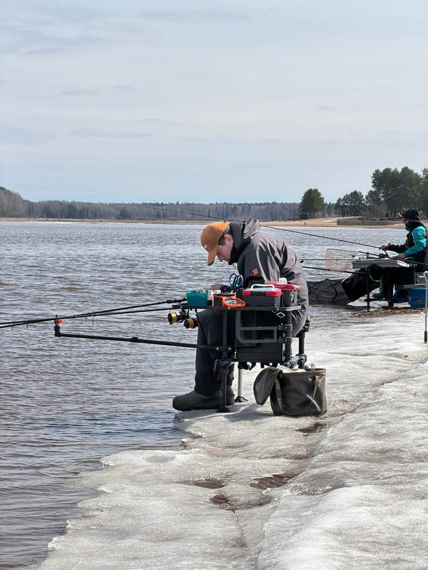 Two anglers fish from frozen bank in Chaikovsky, Russia
