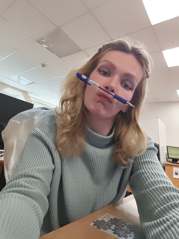 Woman holds pen in office setting