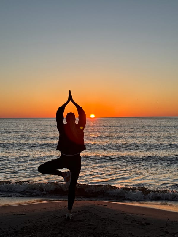 Evening yoga session captured on Latvian beach at sunset