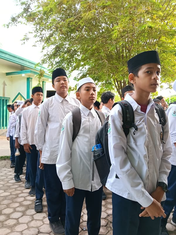 Students queue outside building in Lhokseumawe, Indonesia