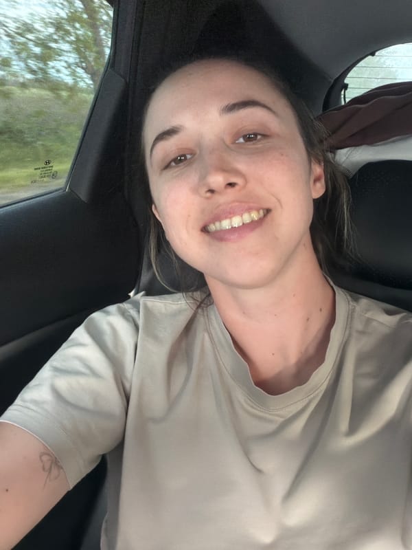 Woman smiles at camera in moving car in Russia
