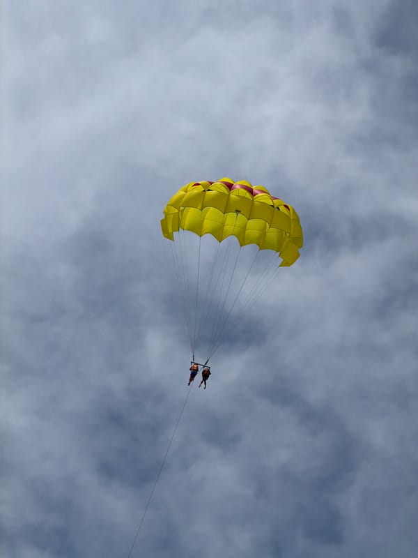 Two parasail under cloudy skies in Serik, Turkey