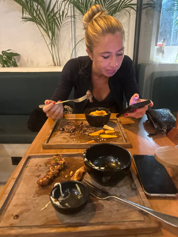 Lunch out at a casual restaurant, food and phones on the table.