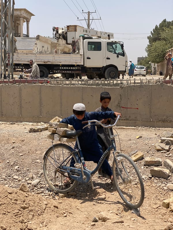 Everyday street life on a dusty Kandahar road