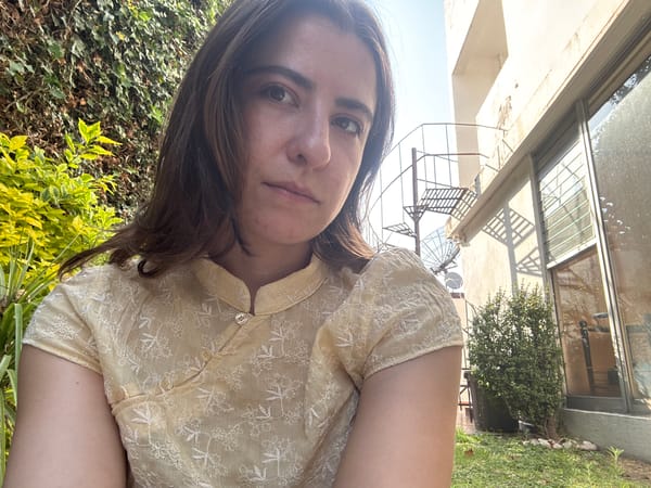 Woman photographed in yellow embroidered blouse in Puebla