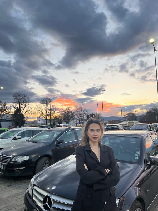 Woman poses with Mercedes at sunset in Bulgarian parking lot