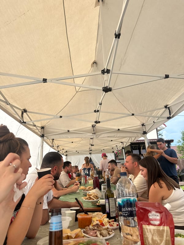 Outdoor feast under a white tent in Sylva, Russia