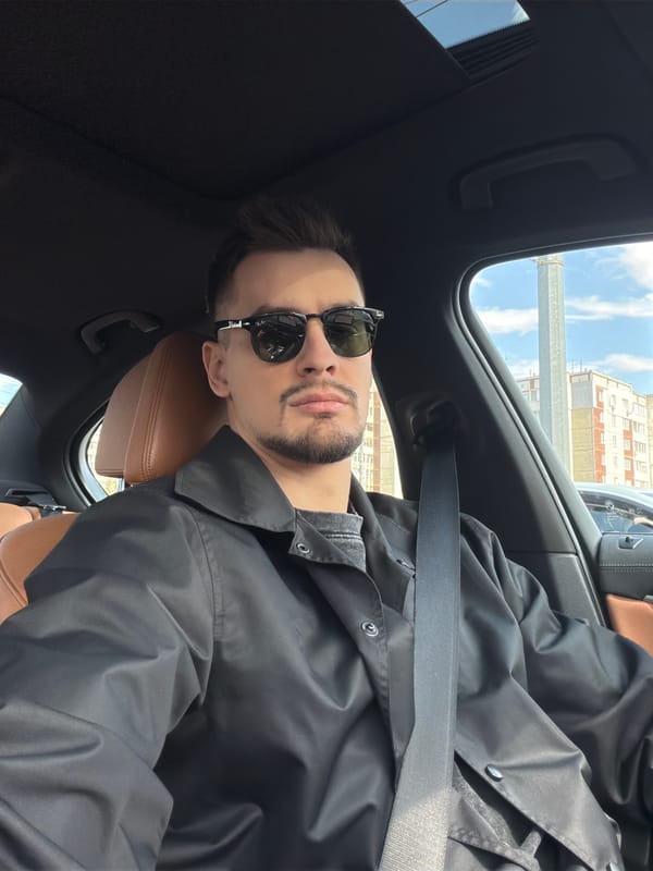 Man in sunglasses sits in car in Krasnoyarsk