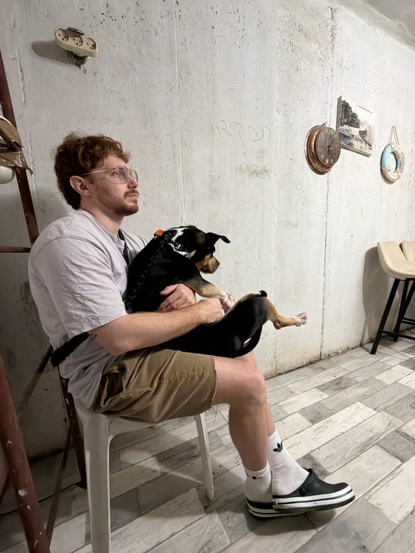 Dog owner enjoys leisurely morning at Tel Aviv park