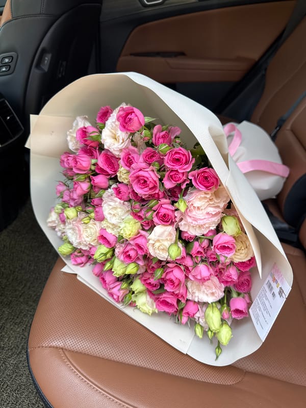 Pink and white rose bouquets filling a car in Almaty