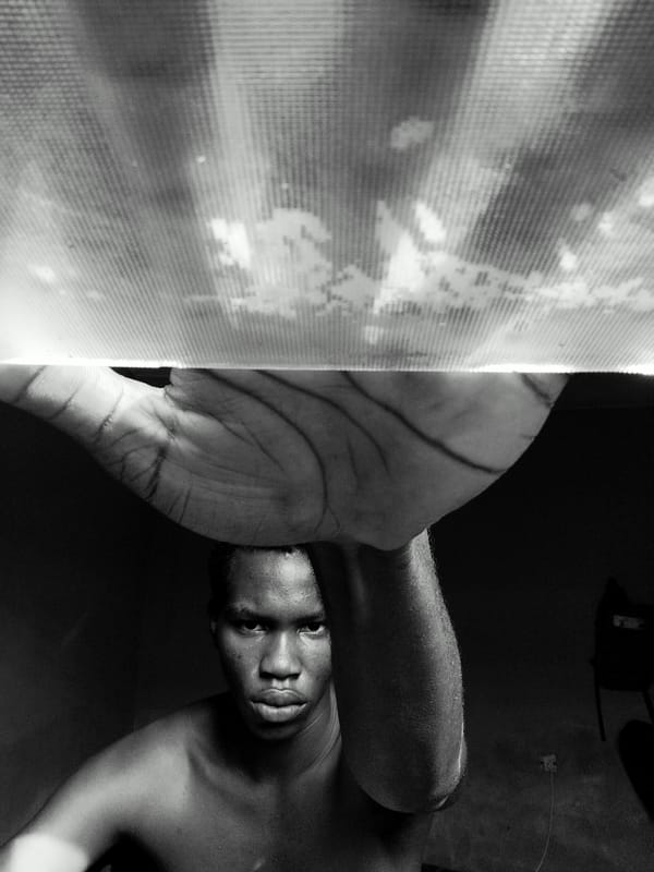 Indoor portrait session captures young man with light fixture