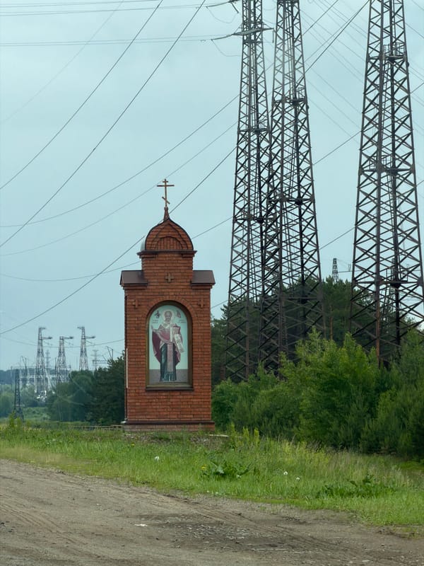 Roadside scene with shrine and Lada captured in Noviy, Russia