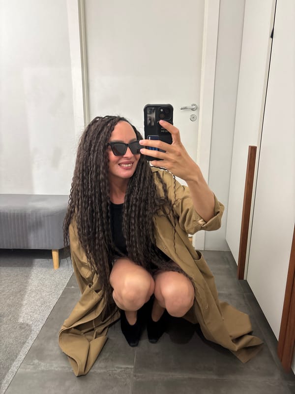 Woman poses with smartphone indoors in Chaikovsky, Russia