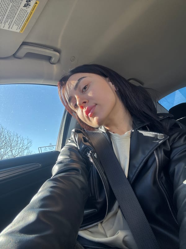 Woman in leather jacket travels by car in Tbilisi