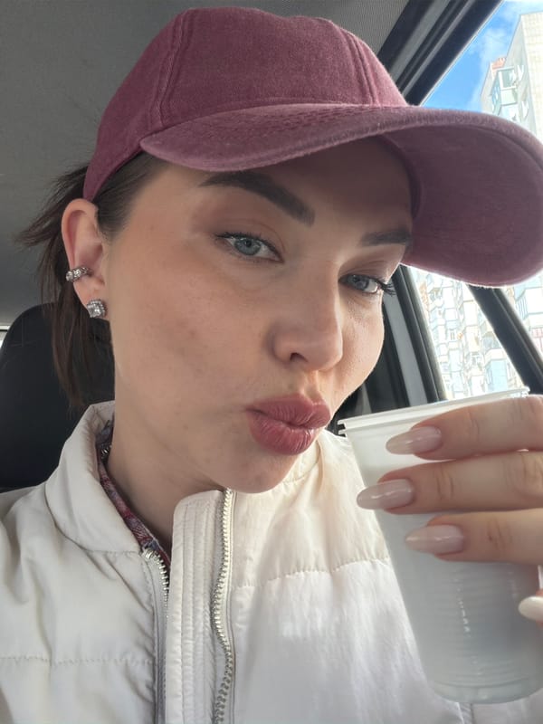Woman makes kissing face with cup in Kamensk-Shakhtinsky