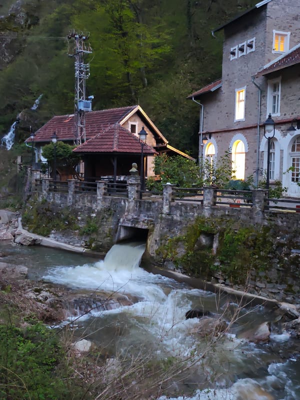 Stone riverside buildings documented at dusk in Vucje, Serbia