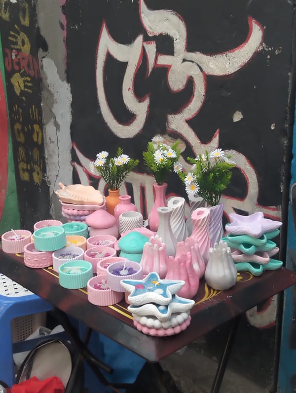Street vendor sells handmade goods at Dhaka market stall