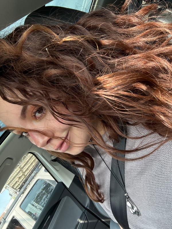 Woman rests in car during evening hours in Mexico City