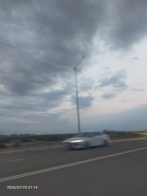 Storm builds over a commercial parking lot at dusk