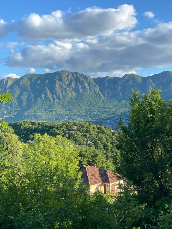 Rural Montenegro scenes documented: mountain valleys and graffitied bus shelter