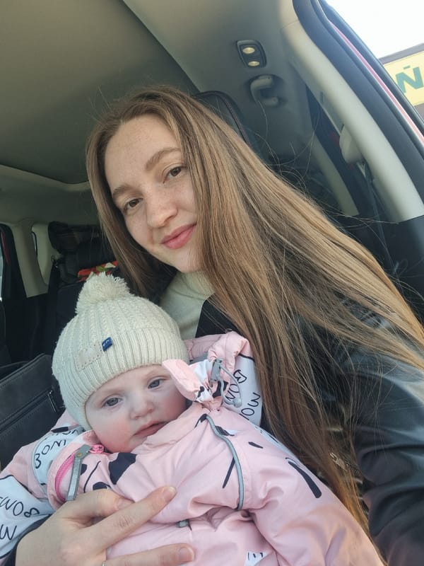 Woman and baby observed in car from high angle