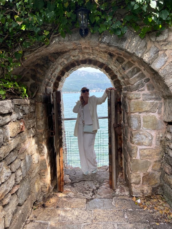 Tourist explores historic Budva Old Town, cafes, coastal views