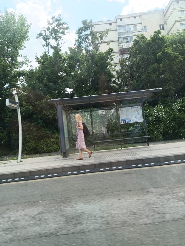 Woman walks past bus stop on Burgas street