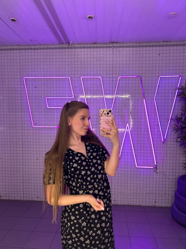 Woman takes selfies in neon-lit venue in Klin, Russia