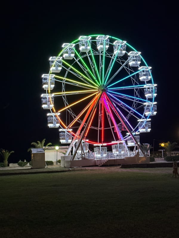 Evening scenes from Budva marina and illuminated Ferris wheel