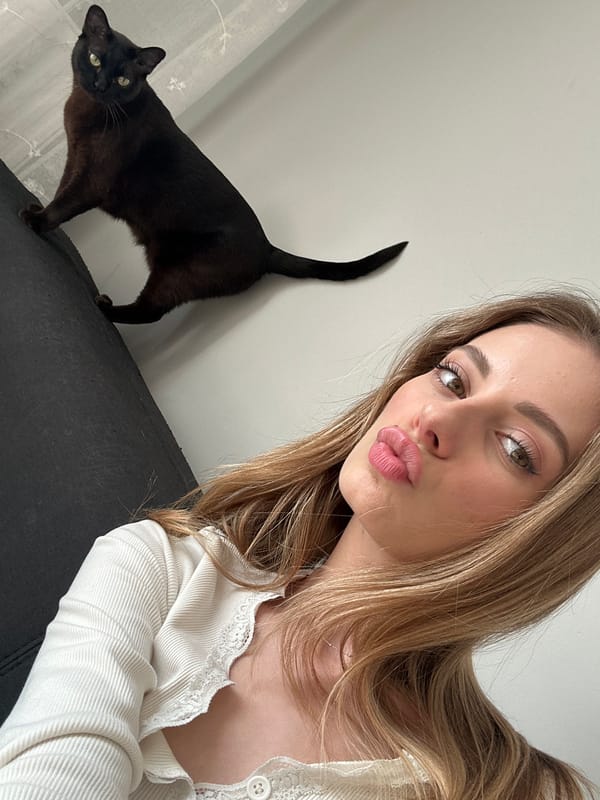 Woman takes selfie with brown cat in Warsaw home