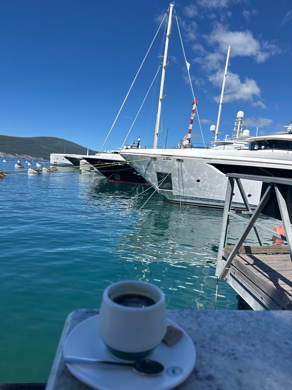 Luxury yachts dock at Tivat marina under clear skies