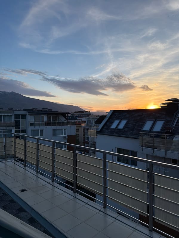 Dramatic sunset captured over Sofia skyline from rooftop