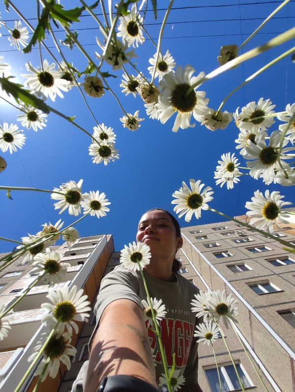 Summer morning in Chaikovsky: flowers, faces, and Brutalist architecture.