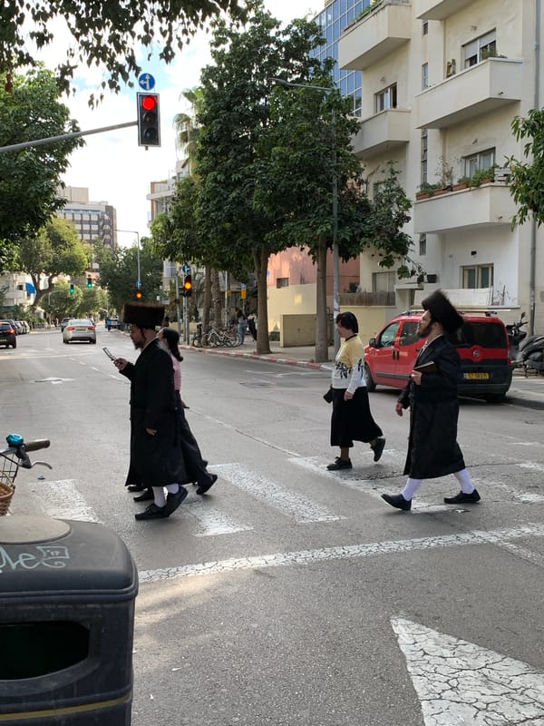Orthodox men cross Tel Aviv street in everyday scene