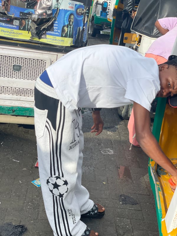 Morning street scene around a Keke Napep in Ado, Nigeria
