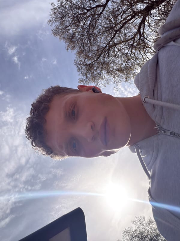 Upward photo captures young person looking down in London