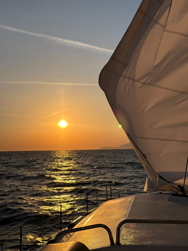 Sailing yacht witnesses golden sunset off Anacapri coast