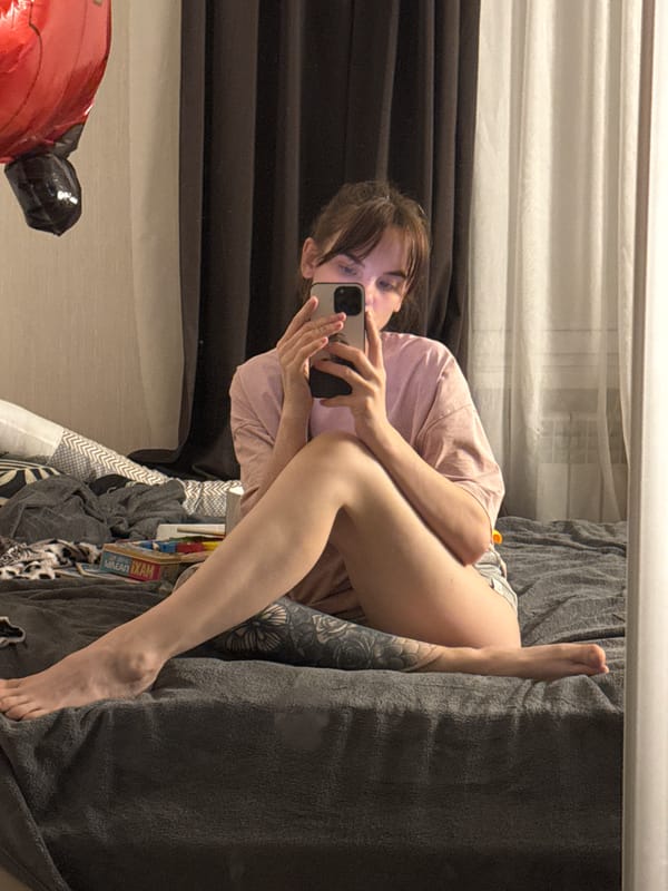 Woman photographs herself resting indoors in Rostov-on-Don